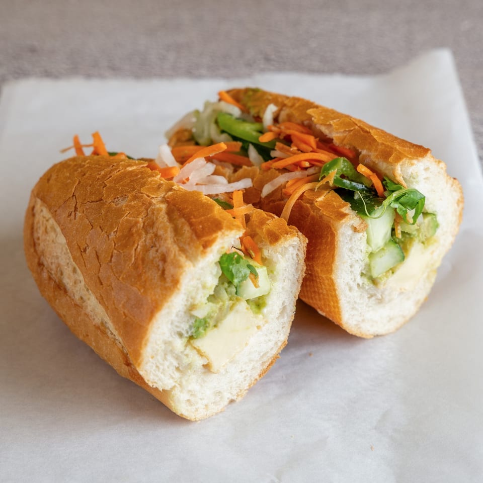 Lemongrass tofu banh mi with fresh herbs and pickled carrots.