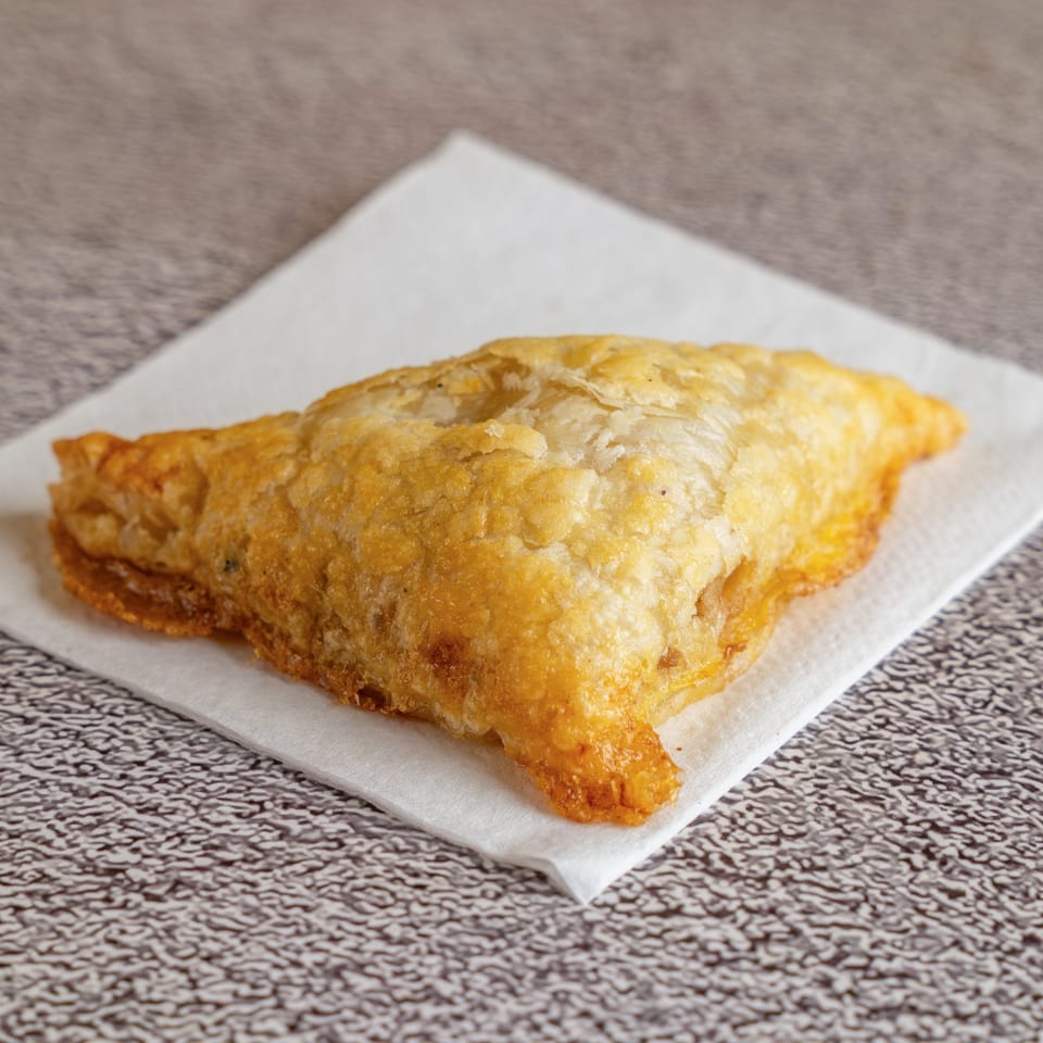 Golden, flaky pate chaud pastry on a napkin.