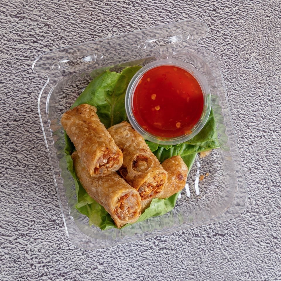 Crispy fried eggrolls with sweet chili dipping sauce and lettuce.
